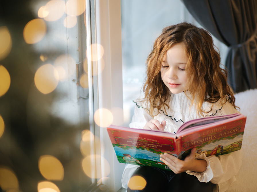 Pige, der læser en stor bog